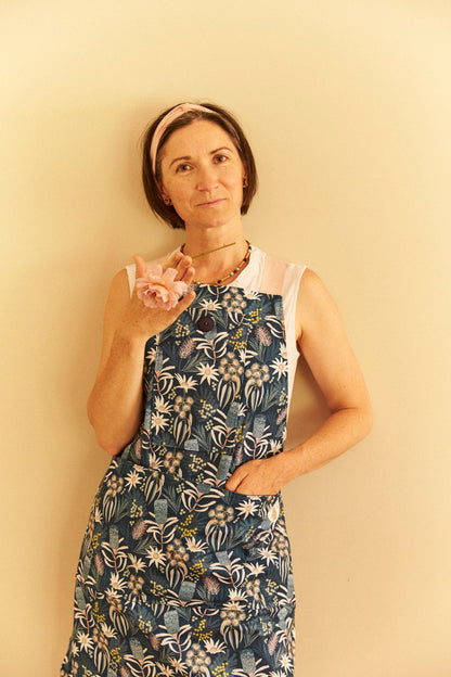 Woman wearing a floral dress against a plain background